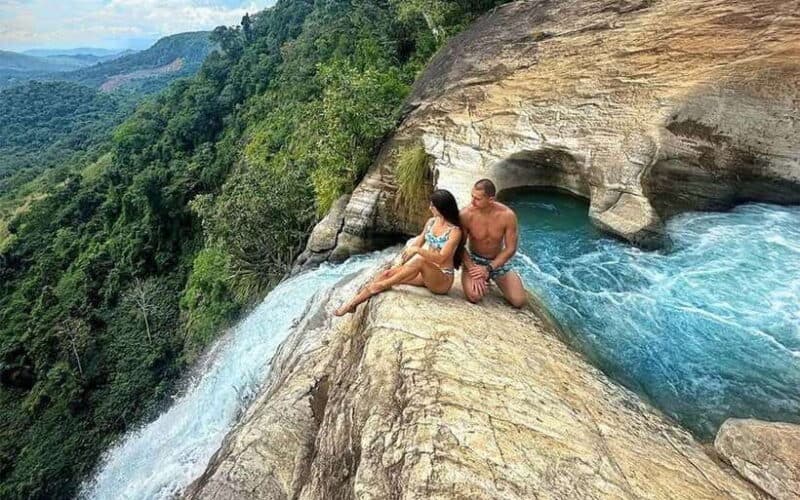 High angle view of the cascading Diyaluma Falls surrounded by lush greenery