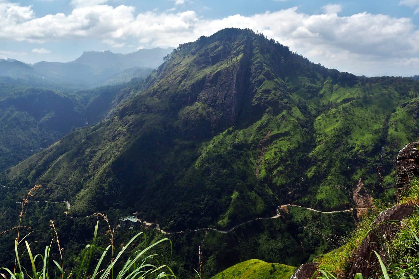 The view from the top of Little Adam's Peak across to Ella Rock, with the road winding below